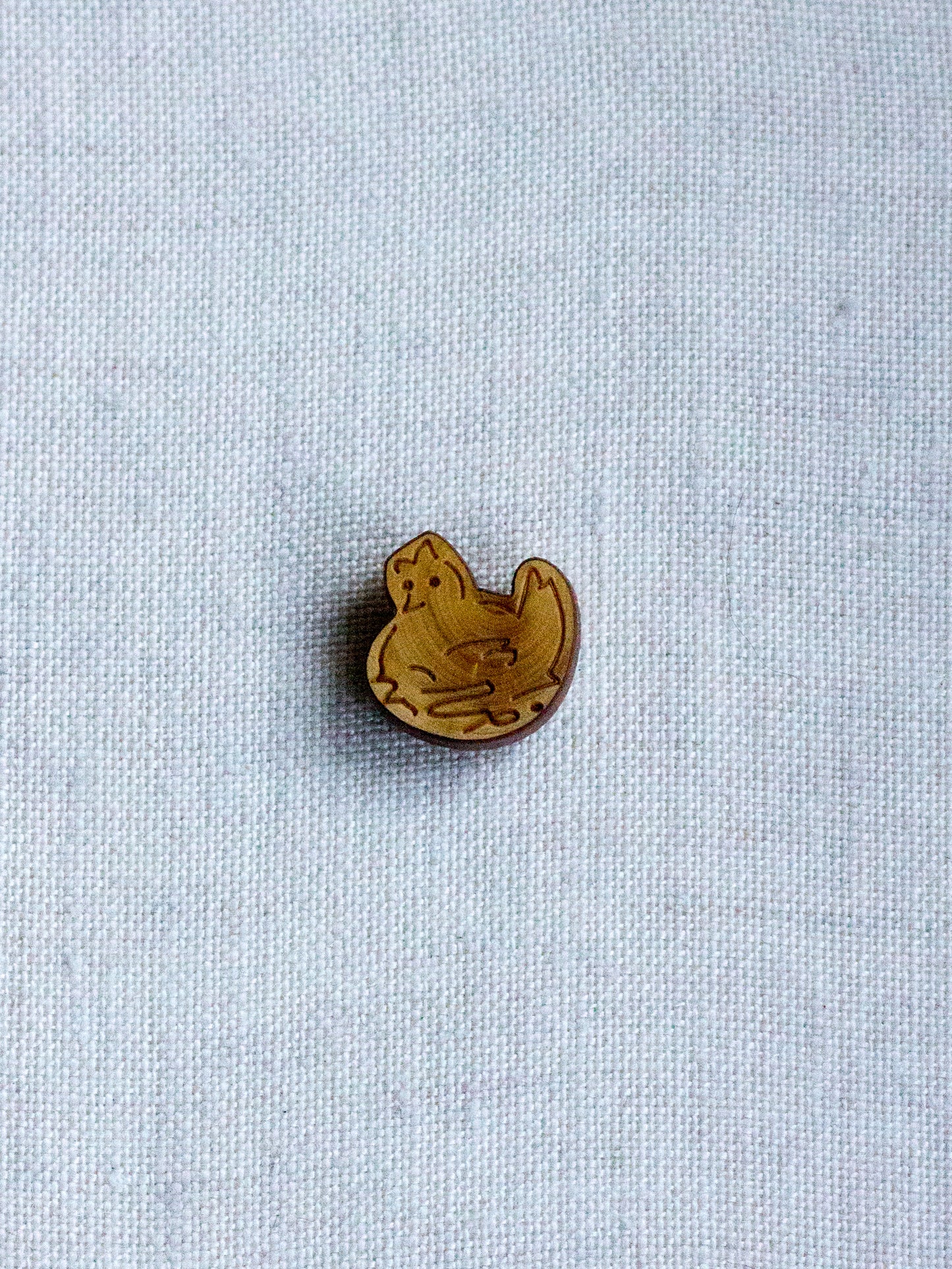 Picoti hen on nest button